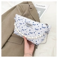 Détail du sac blanc à texture bulle avec motifs papillons bleus et poignée en perles - Bleu
