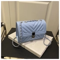 Detail of light blue chevron quilted leather bag with silver chain and metal push-lock - Blue