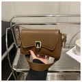 Detail of dark brown leather baguette bag featuring a gold rectangular twist lock closure - Coffee