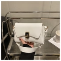 Close-up of white PU leather square handbag with gold metal lock on a display shelf - White