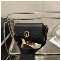 Detail of a vintage black shoulder bag with a textured finish and golden twist lock - Black