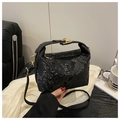 Chic black snake print bucket bag with gold hardware and adjustable crossbody strap - Black