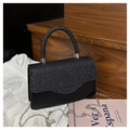 Detailed close-up of a black glitter evening clutch with silver chain on wood stairs - Black