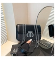 Close-up of black chain crossbody bag featuring sequin patchwork and silver metal buckle - Black