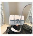 Detail of a chic chain shoulder bag with white leather flap and silver sequin stitching - Silver