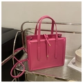 Detail of rose red PU leather handbag with decorative drawstring knot on a metal shelf - Rose Pink