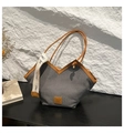 Chic grey canvas tote bag with brown leather trim and stylish woven handle details - Black