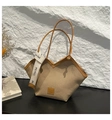 Khaki canvas woven tote bag with brown leather handles and decorative white ribbon - Brown