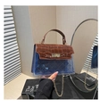 Detail of blue transparent PVC bag with brown crocodile texture flap and gold lock - Brown