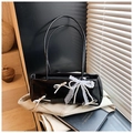 Close-up of black glossy pillow bag with white bows and pearl lace charm detail - With Pendant / Black