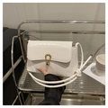 Détail du sac à bandoulière blanc motif crocodile avec boucle dorée sur étagère - Blanc
