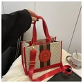 Detail of stylish color-block tote bag with elegant golden logo and wide shoulder strap - Red