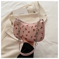 Close-up of pink cherry print shoulder bag with silver chain strap and metal zipper - Pink