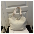 Detalle de la textura de lona gruesa y la correa ancha reforzada del bolso tote minimalista - Blanco