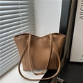 Large caramel brown PU leather tote bag with minimalist design and sturdy shoulder straps - Brown