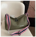 Detail of army green canvas bag featuring dual zippers and a striped fabric strap - Green