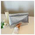 Close-up of the silver woven texture on a minimalist envelope clutch with a metal finish - Silver