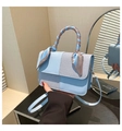 Detail of light blue PU leather bag with silk scarf handle and textured weave pattern - Blue