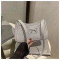 Detailed view of shimmering silver sequin shoulder bag with metallic bow and chain strap - Silver
