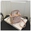 Detailed macro view of pink quilted handbag with gold hardware on a white background - Pink