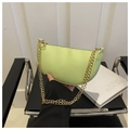 Detail of neon green lychee leather baguette bag with elegant golden chain strap - Green