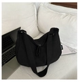 Minimalist black nylon crescent shoulder bag with wide strap on a white bed - Black
