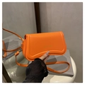 Bright orange crossbody bag with wavy base design and gold fashion lettering detail - Orange