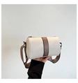 Detail of cream barrel bag showing lychee grain leather and geometric webbing strap - White