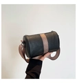 Detail of black lychee grain leather cylinder bag with stylish wide vintage shoulder strap - Black