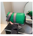 Detail of green leather barrel bag with textured finish and woven geometric strap - Green