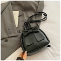 Close-up of a black matte PU leather mini backpack featuring a large bow decoration - Black