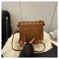 Close-up of brown leather tassel bag with silver rivets and sleek crossbody strap - Dark Brown