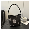 Vista dettagliata della borsa a secchiello nera con eleganti stampe floreali e manico - Nero