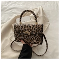 Leopard print crossbody bag with gold bow detail and curved handle on beige blazer - Khaki