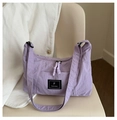 Minimalist purple nylon tote bag with adjustable shoulder strap on a beige chair - Purple