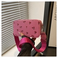 Detail of pink cherry print crossbody bag featuring a wide magenta nylon shoulder strap - Pink