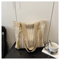 Detail of minimalist straw tote bag featuring long tassels and woven vertical stripes - White
