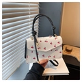 Detail of white square handbag featuring red cherry prints and knotted black handle - Black