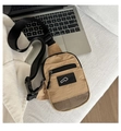Close-up of khaki nylon chest bag featuring hex-mesh pocket and adjustable strap detail - Khaki