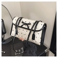 Close-up of minimalist black and white bow pattern handbag with elegant leather handle - White Without Pendant