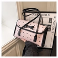 Detail of pink fabric shoulder bag featuring black bow patterns and dual slim straps - Pink Without Pendant
