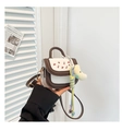 Detail of mini cherry print handbag with detachable strap and plush charm - Brown with Pendant