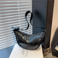 Minimalist black crescent crossbody bag in glossy faux leather with silver buckle - Black
