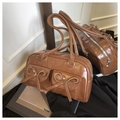 Brown glossy faux leather shoulder bag with pockets and bow detail in variant view - Brown