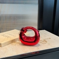 Metallic red crescent-shaped handbag with a gold chain strap for high-fashion wear - Red