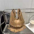 Bohemian style khaki fringe tote bag made of PU leather hanging on a modern chair - Khaki