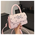 Pink quilted crossbody bag with black bow prints and silver metallic bow hardware - Pink