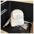 Close-up of a white leather crossbody phone bag inside a luxury black gift box - White