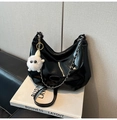 Detail of glossy black patent leather tote bag with silver chain and plush charm - Black (With Charm)