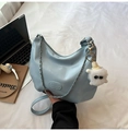 Light blue glossy hobo bag with adjustable strap and cute plush charm on a white surface - Blue (With Charm)